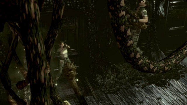 Chris Redfield is snagged by Plant 42 as Rebecca Chambers watches on in Resident Evil (2002)