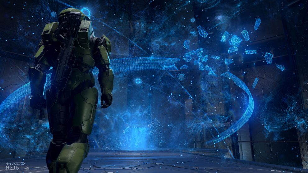 The Master Chief, supersoldier protagonist of the Halo series of video games, walks towards a blue hologram of a shattered ring-like structure whihc fills the room.  