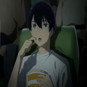 Tsuneo eating popcorn while watching film in cinema