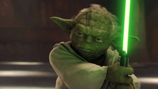 Yoda wielding a lightsaber in Star Wars