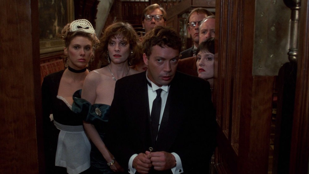 Tim Curry as Wadsworth and the rest of the cast in Clue