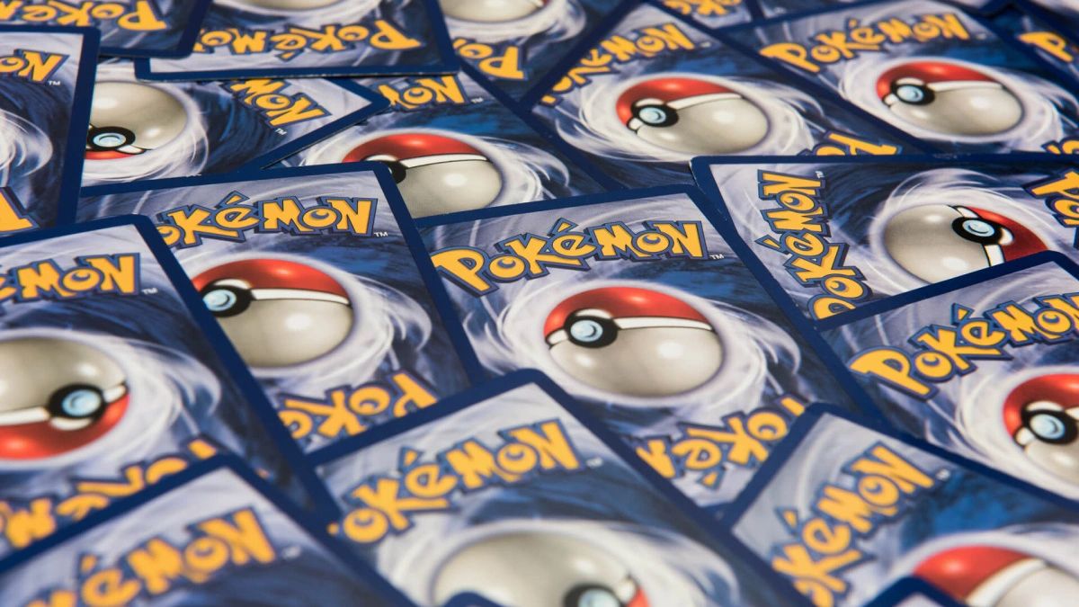 Pokemon cards scattered on top of one another, showing the logo on the back