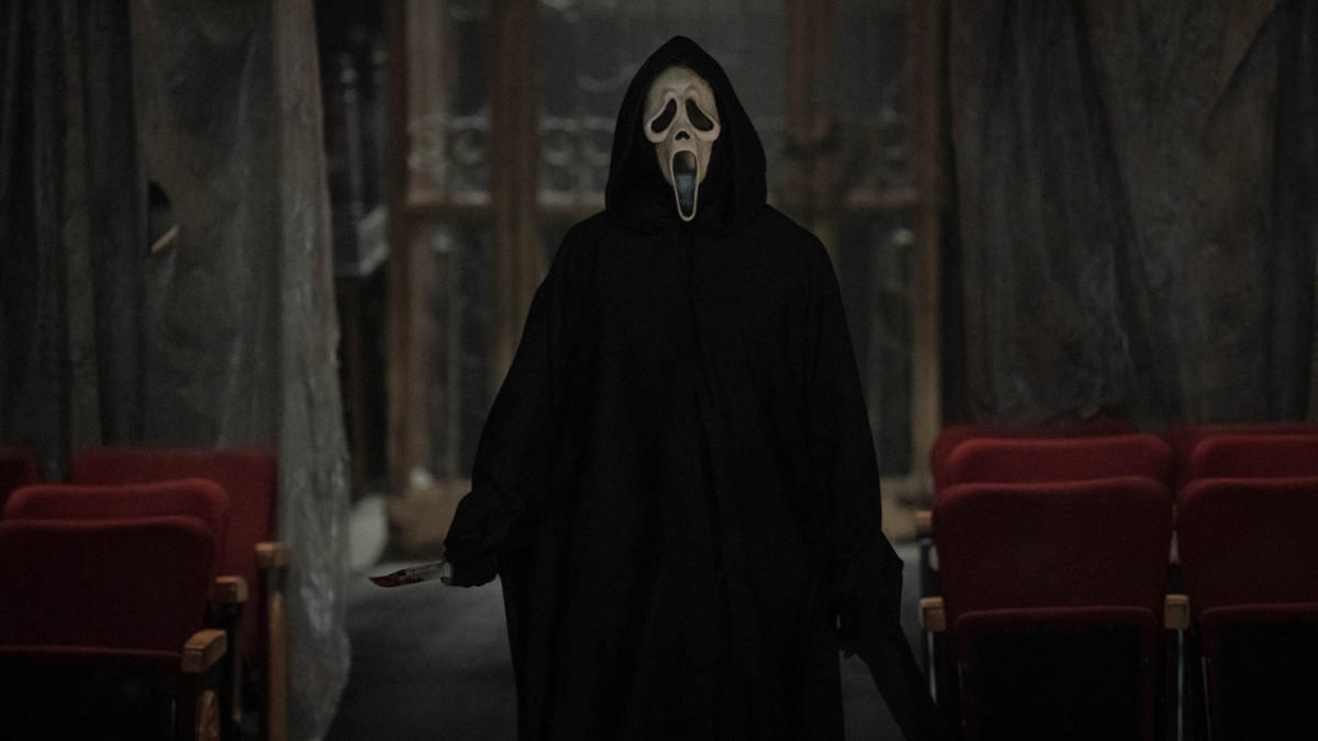Ghostface holding a bloody knife in an abandoned theater (from Scream 6)