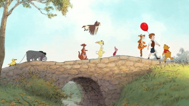 Winnie the pooh and friends walking over a bridge together in the Hundred Acre Wood.
