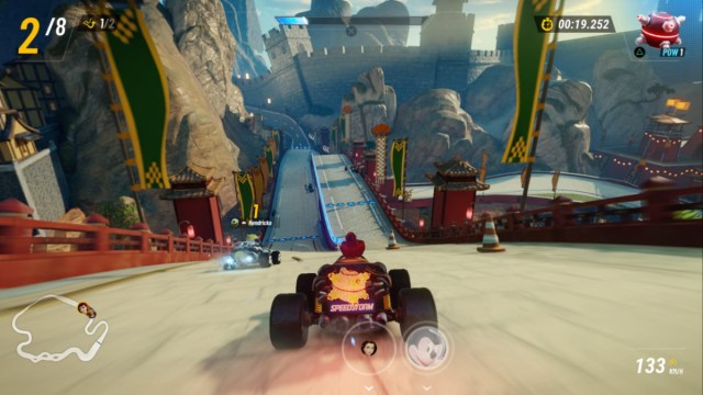 Meg racing The Big Wall track in Disney Speedstorm.