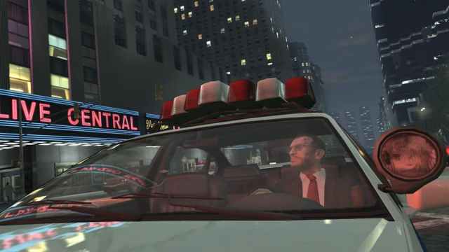 Niko Bellic from GTA IV in a police car