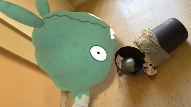 A screenshot of Trubbish with a trash bin from Pokemon GO