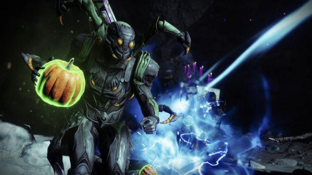 A Titan holding a pumpkin in Destiny 2 while wearing Halloween armor ornaments