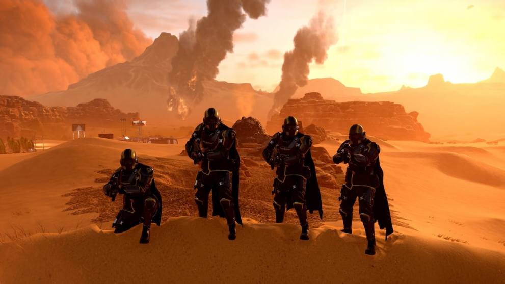 Four helldivers in Helldivers 2 on a sandy planet