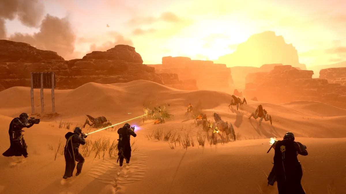 Players running across a desert in Helldivers 2.