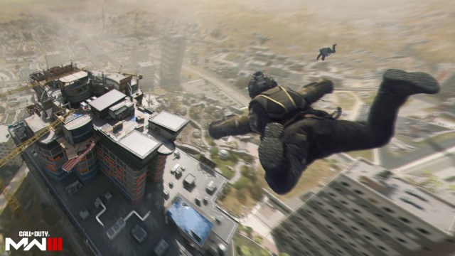 An operator parachuting onto a building in MW3.