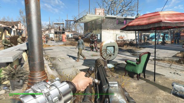 first person view of a big gun pointed at a small post apocalyptic enclave