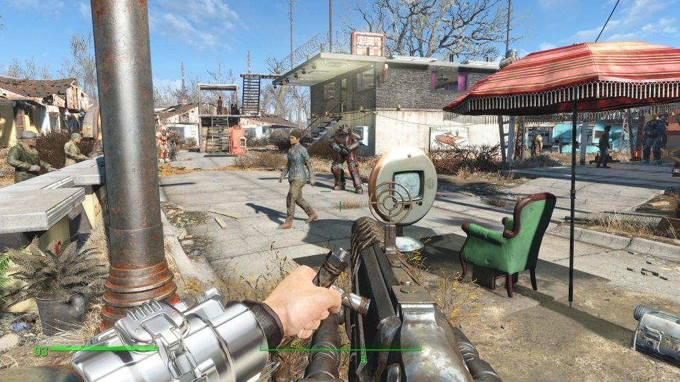 first person view of a big gun pointed at a small post apocalyptic enclave
