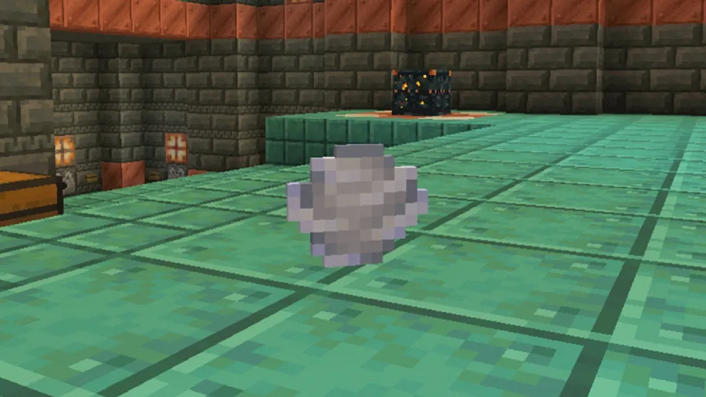 minecraft grey wind charge item on green floor tiles