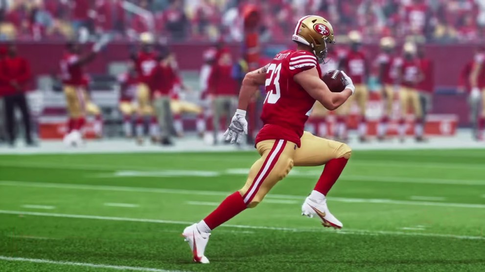 Player running on the field holding the ball