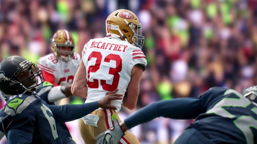 McCaffrey football player running through the field with other players