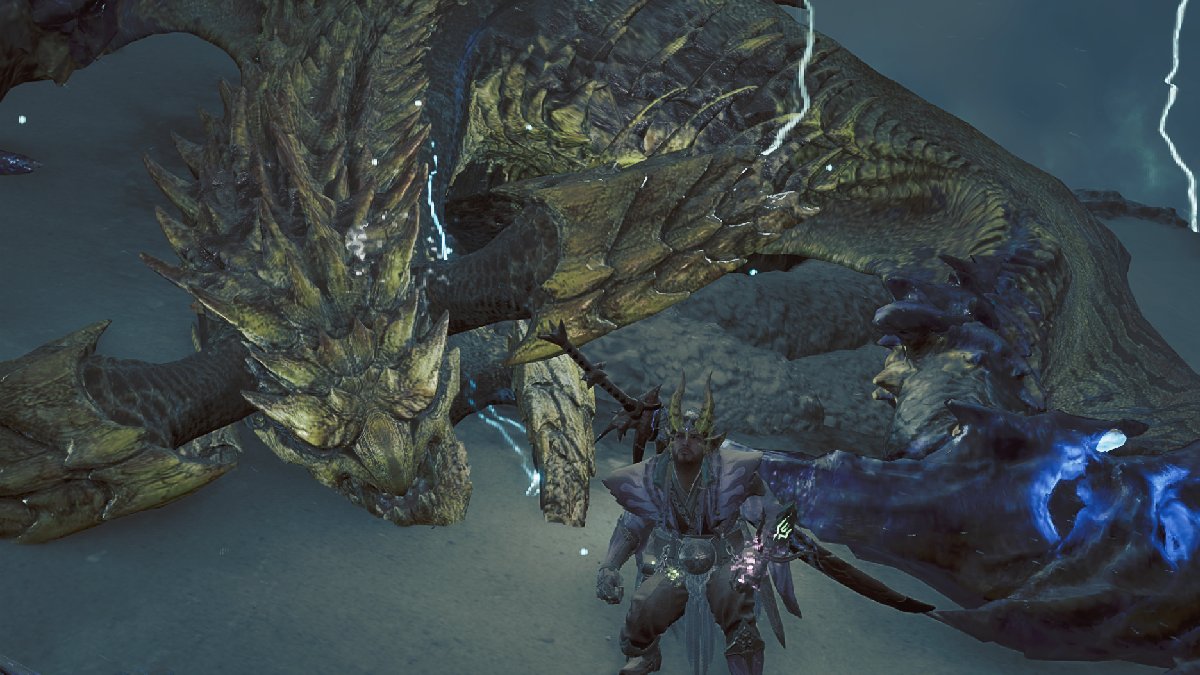 Monster Hunter Wilds captured monster rey dau with player crouching next to it